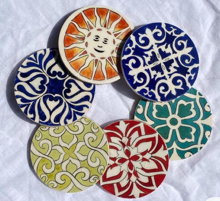 hand-painted ceramic coasters, likely in the style of Jaipur Blue Pottery 